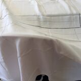 Old white tablecloth in thread with tangles of embroidered days central monogram