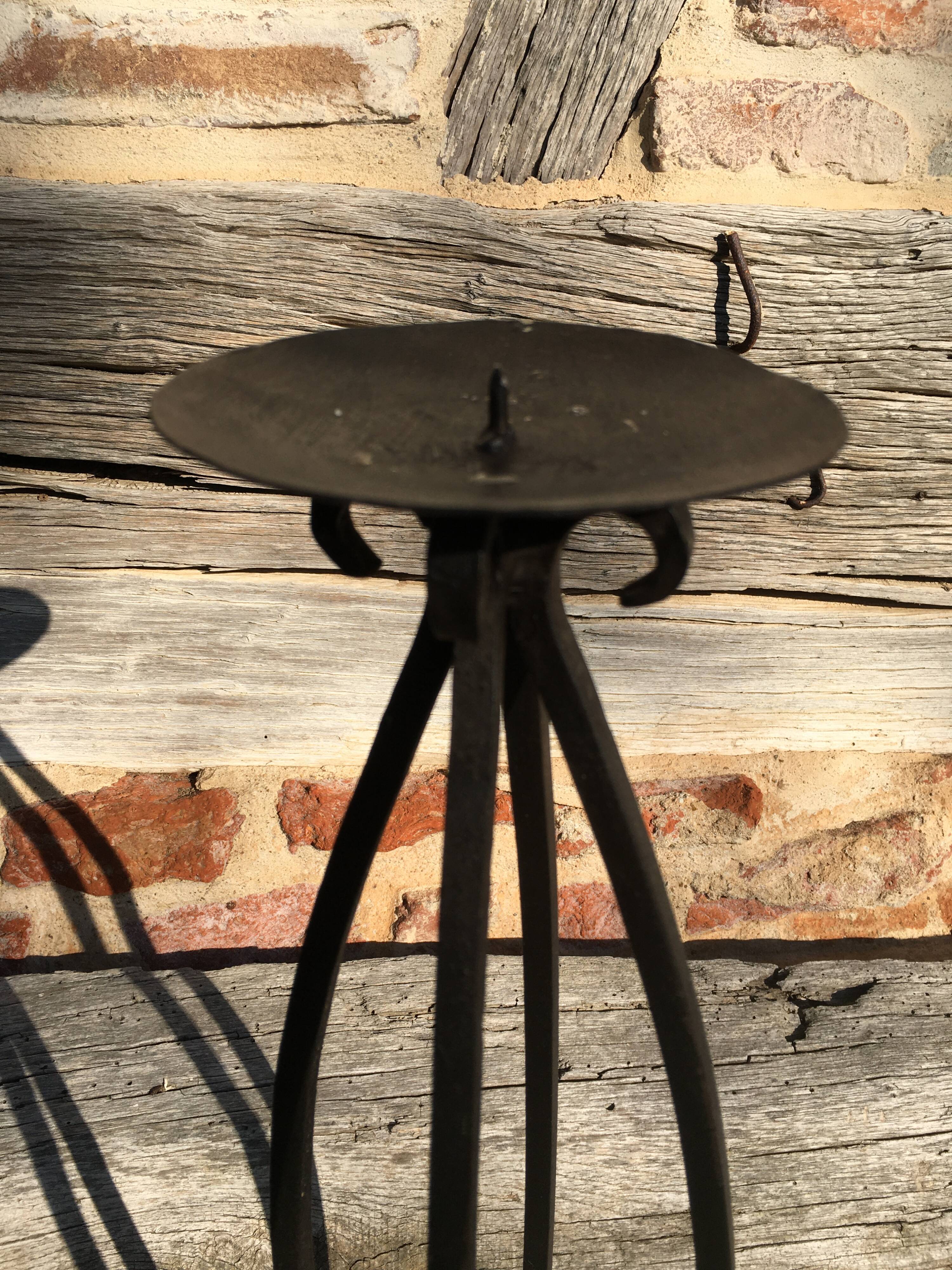 Wrought iron candlestick on feet