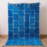 Handmade traditional pure wool carpet with blue patterns.