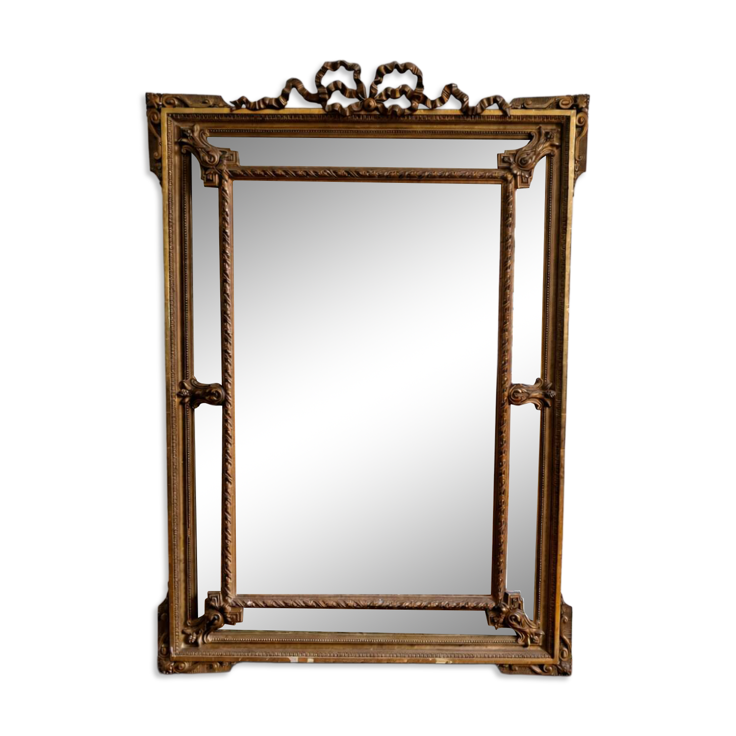 Large Napoleon III mirror 130 × 93 cm — gilded frame sculpted with ribbon pediment.