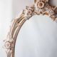 Antique oval mirror carved in wood.