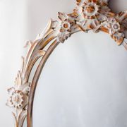 Antique oval mirror carved in wood.