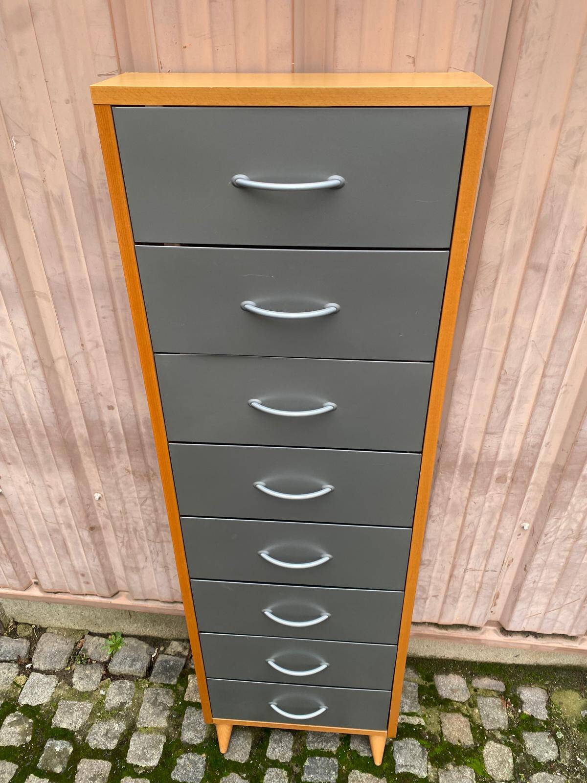 Scandinavian shoe storage cabinet in grey wood and metal.