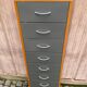 Scandinavian shoe storage cabinet in grey wood and metal.