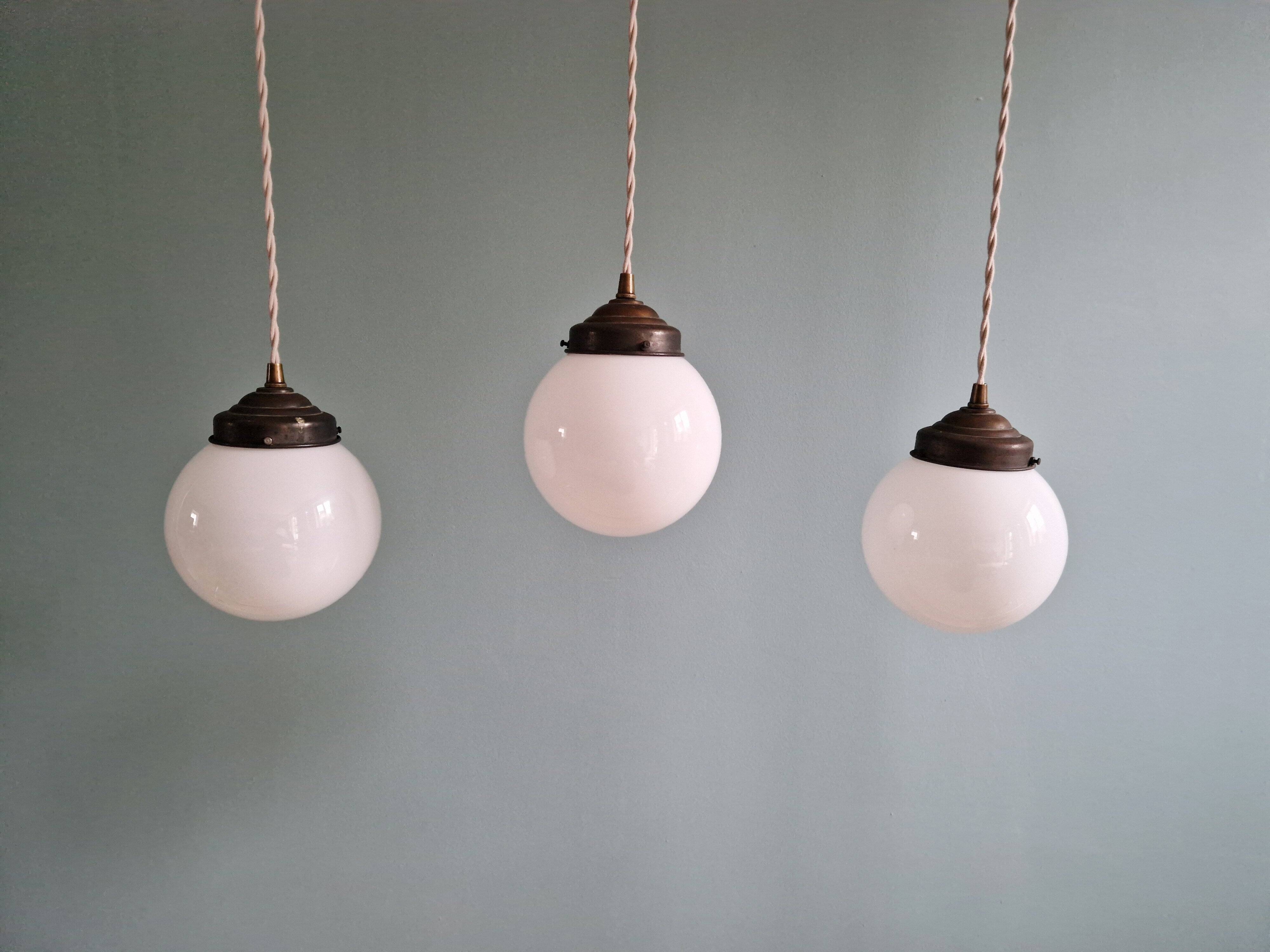 Art Deco trio of suspensions in white opaline, 1930s