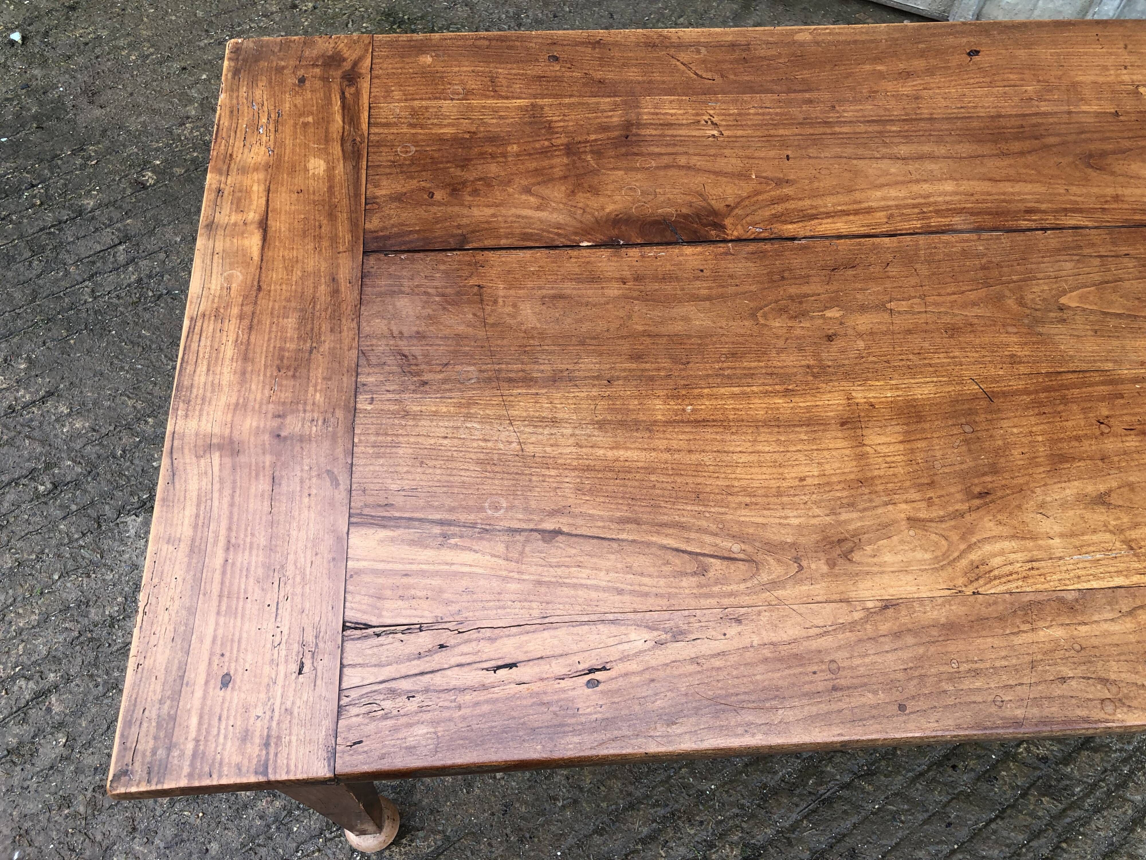 Antique solid cherry farmhouse table with 2 end drawers and 1 pull-out.