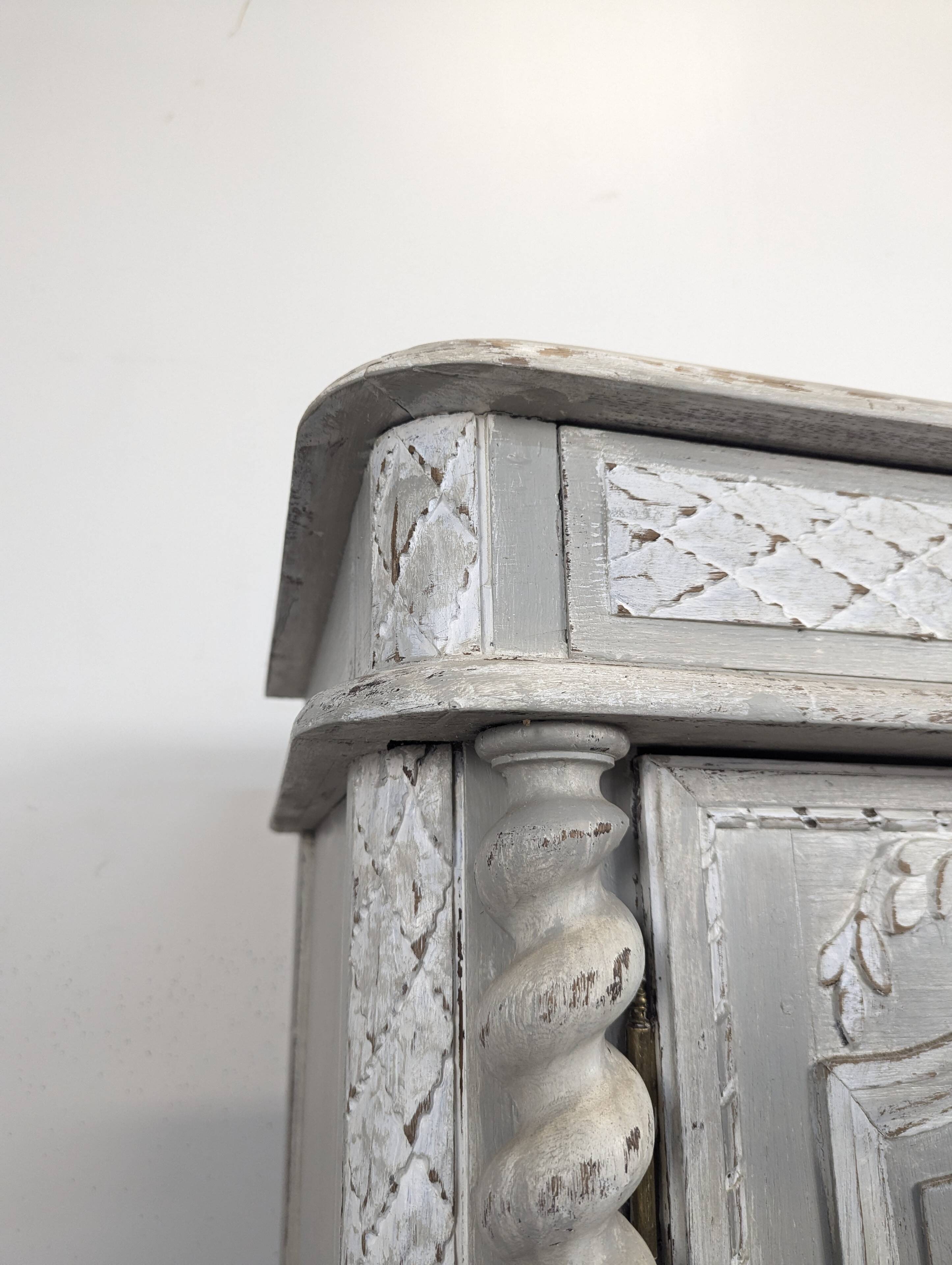 Louis XIII buffet with twisted column in grey patinated oak, two doors, two drawers.