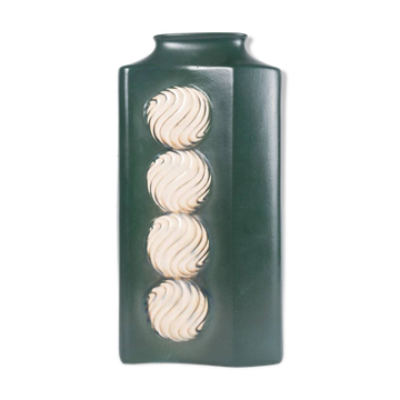 A tall ceramic vase glazed with dark green colour