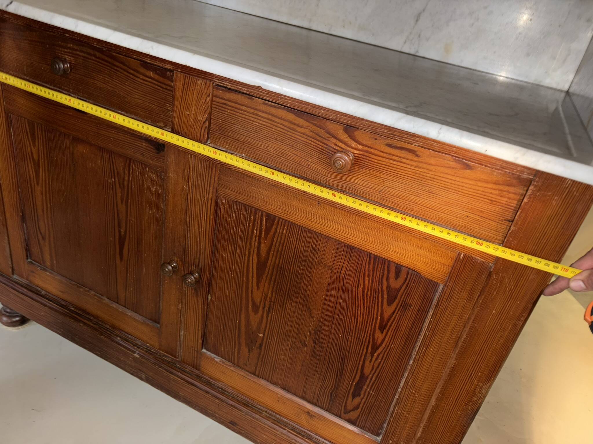 Antique wood and marble kitchen sideboard with carved backsplash