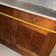 Antique wood and marble kitchen sideboard with carved backsplash