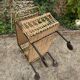 Vintage 1950s rolling dessert trolley in wicker and black tubing.