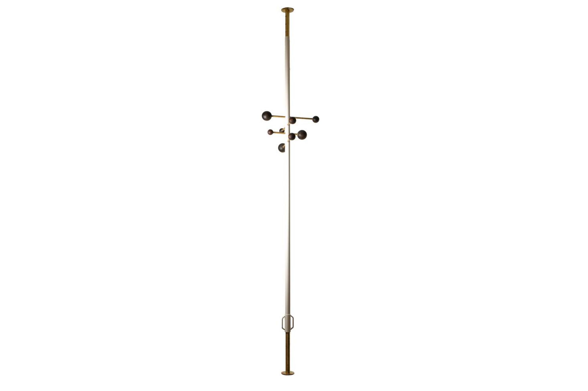 Coat rack from floor to ceiling in lacquered metal and brass. Contemporary.