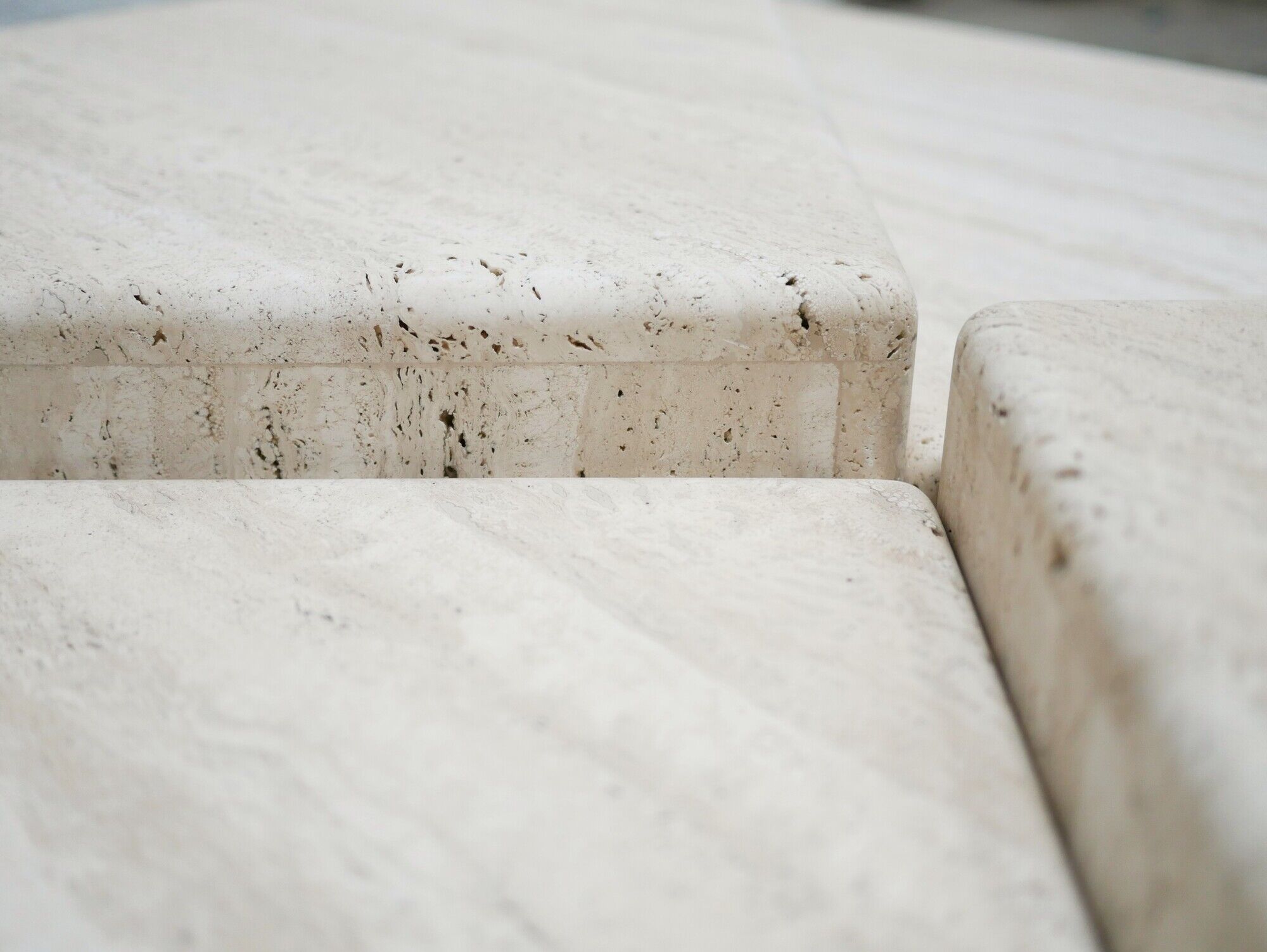 Series of 2 vintage travertine coffee tables published by Roche Bobois