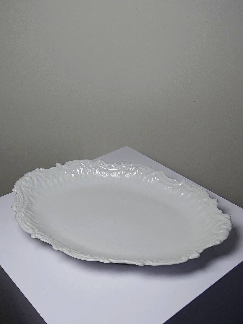 Antique deep dish in white Limoges porcelain, with rockwork relief.