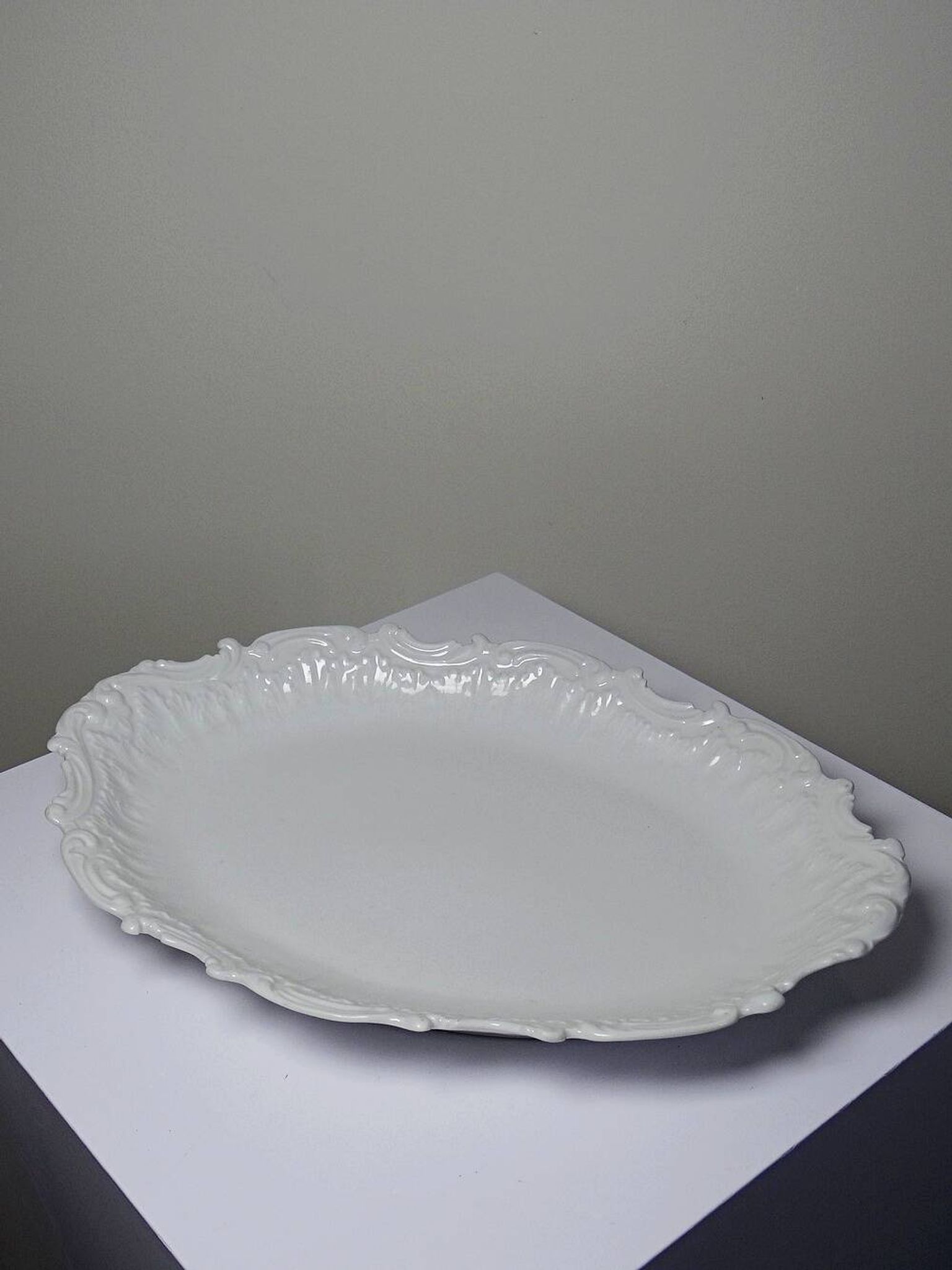 Antique deep dish in white Limoges porcelain, with rockwork relief.