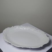 Antique deep dish in white Limoges porcelain, with rockwork relief.