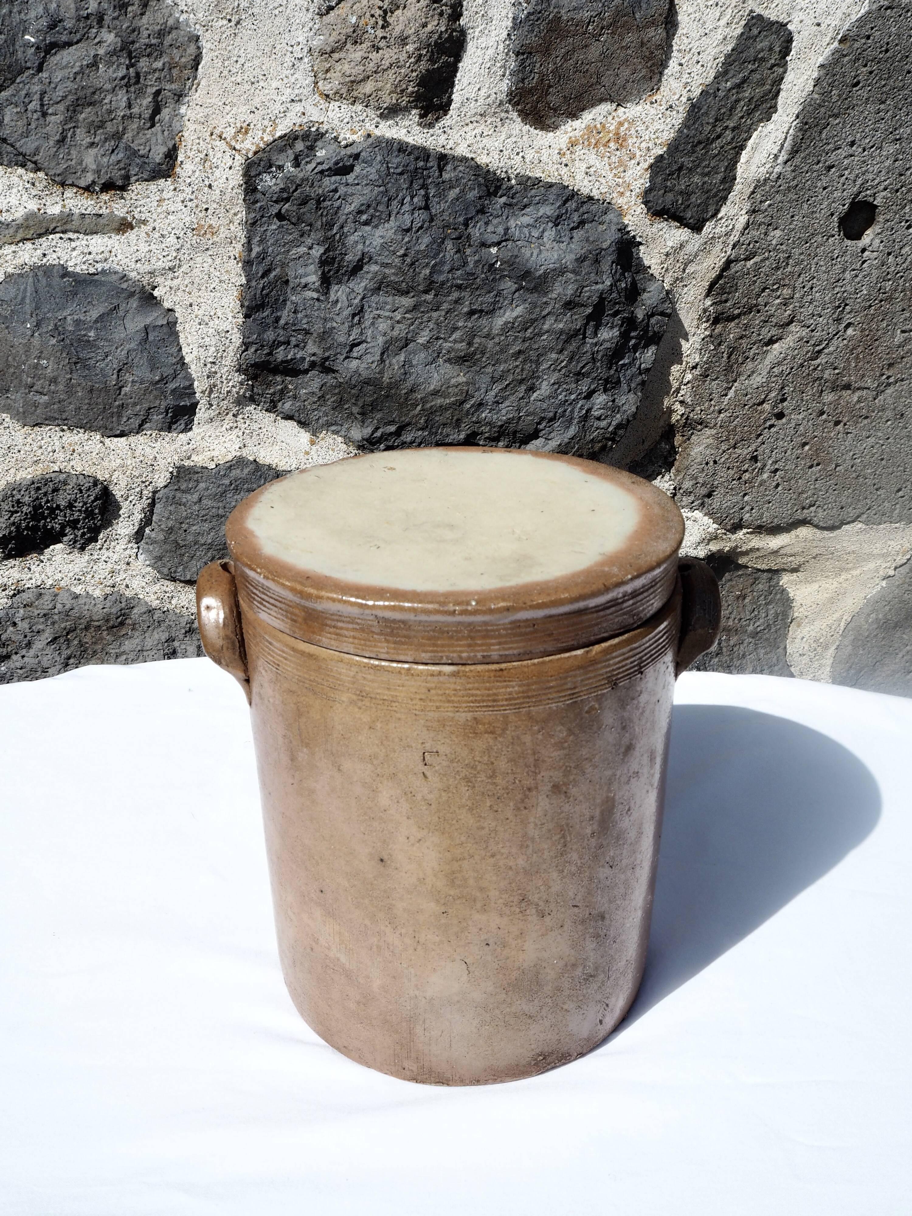 Trio of stoneware pots with lids