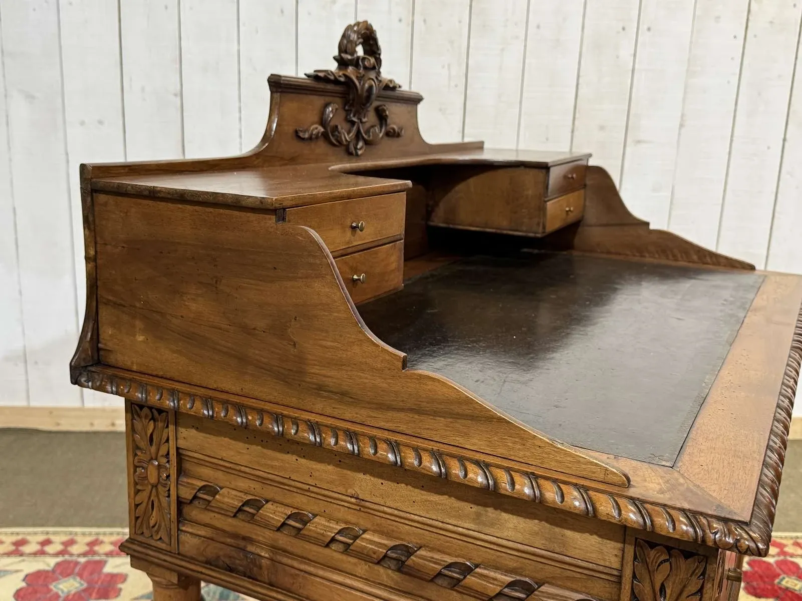 Louis XVI style desk from the late 19th century in walnut with a leather top.