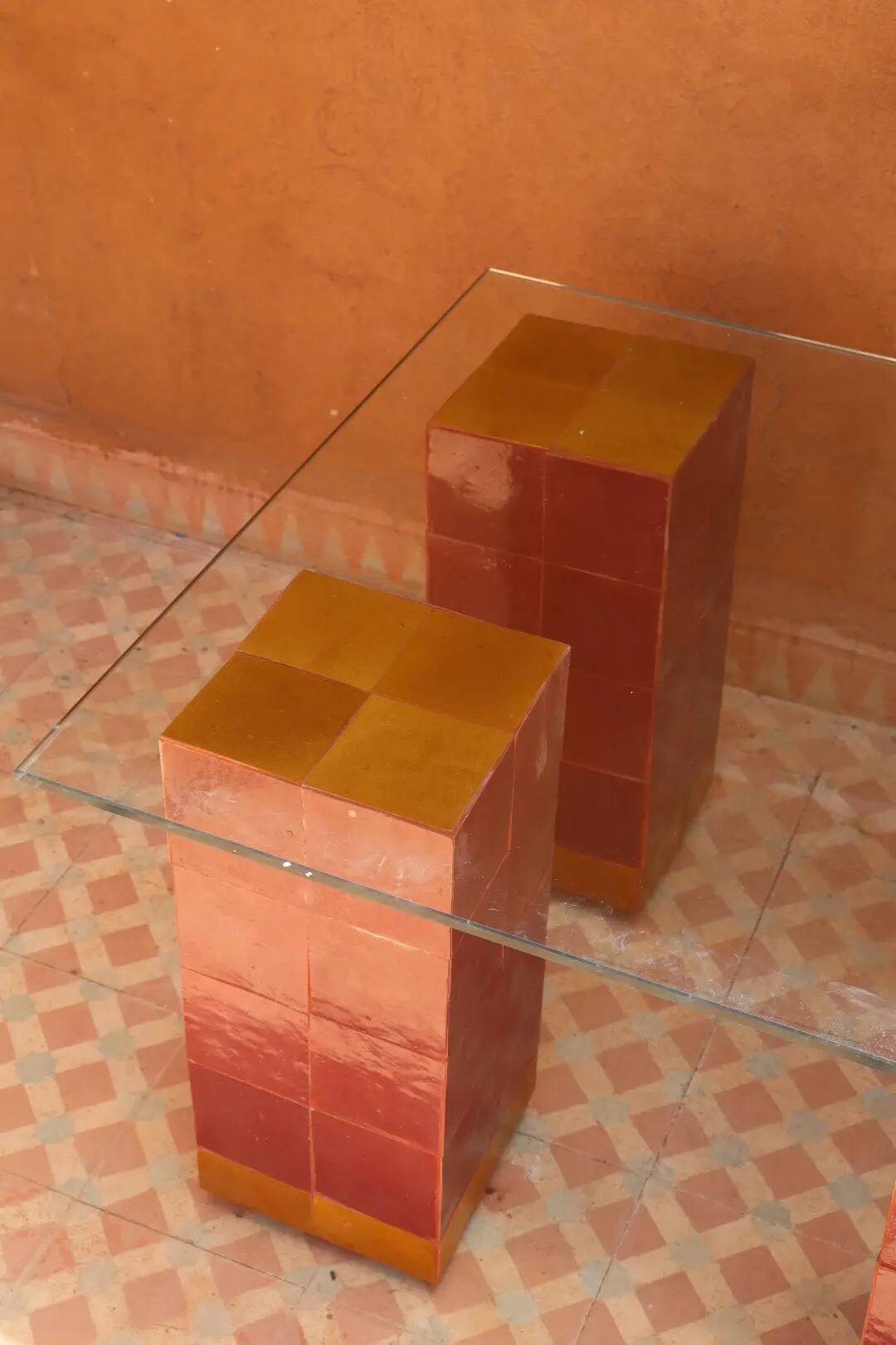 Modern coffee table in burgundy zellige with a tempered glass top.