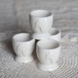 Vintage white porcelain egg cups with fruit motif.