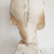 Bust of woman in plaster on pedestal with inscription
