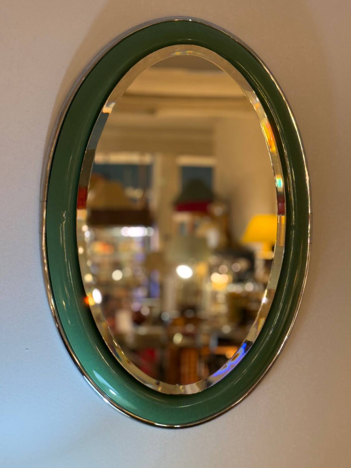 Vintage oval mirror with English green lacquered curved frame and chrome surround