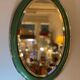 Vintage oval mirror with English green lacquered curved frame and chrome surround