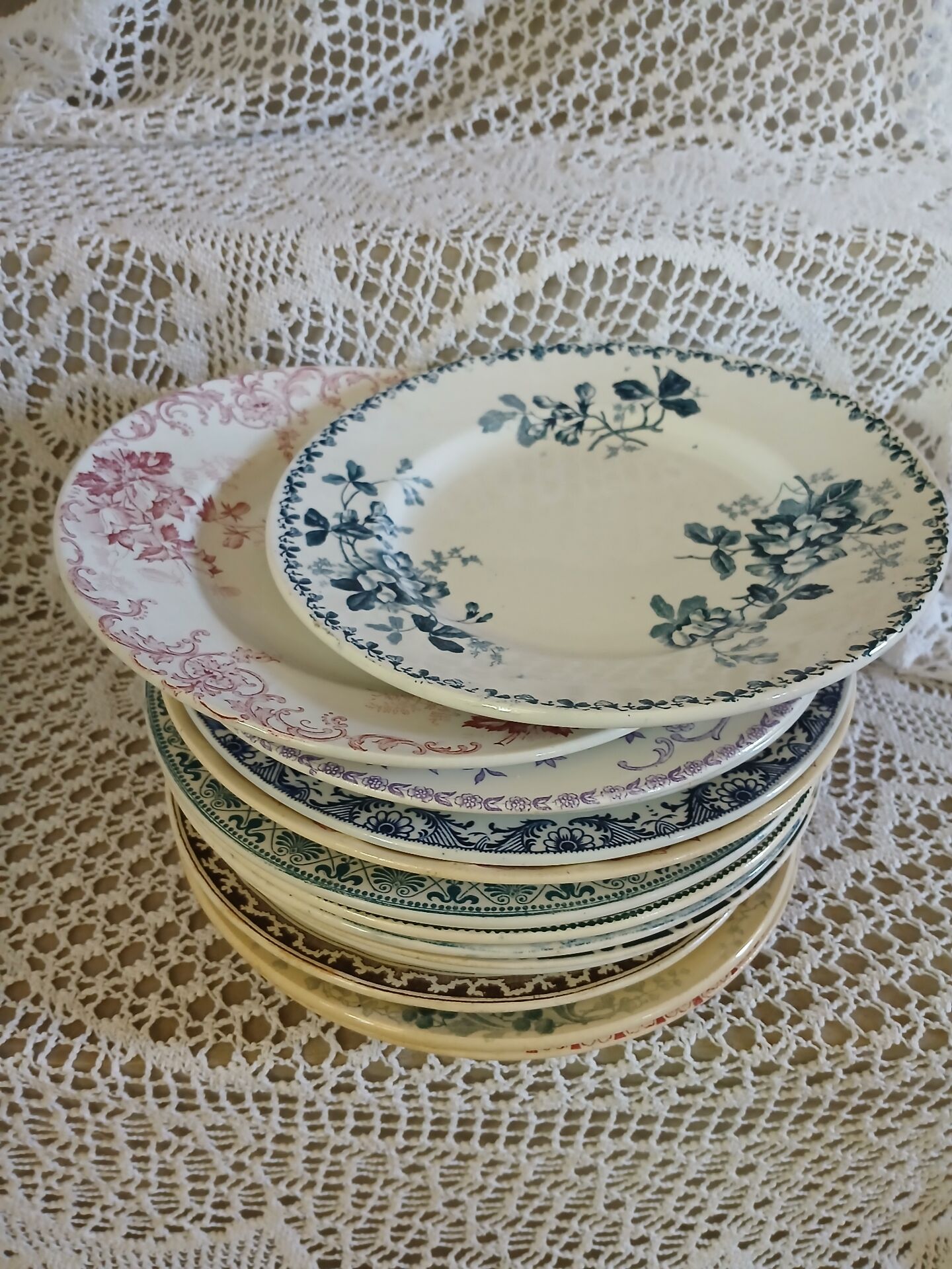 13 mismatched flat plates in ironstone