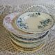 13 mismatched flat plates in ironstone