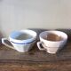 A set of 2 Digoin Sarreguemines cups with pink and blue flowers.
