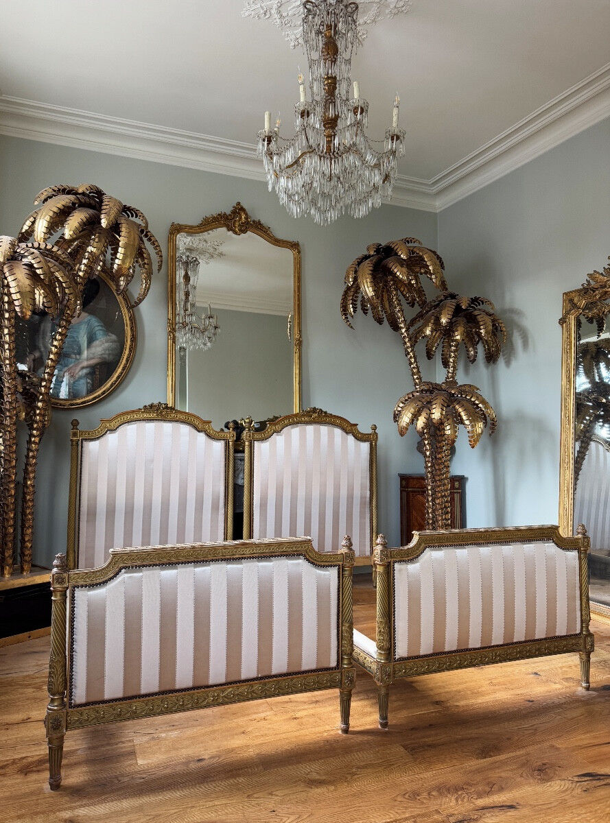 Pair of late 19th-century gilded wooden beds in Louis XVI style.