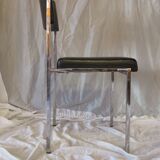Modernist chair in chromed metal and black imitation leather