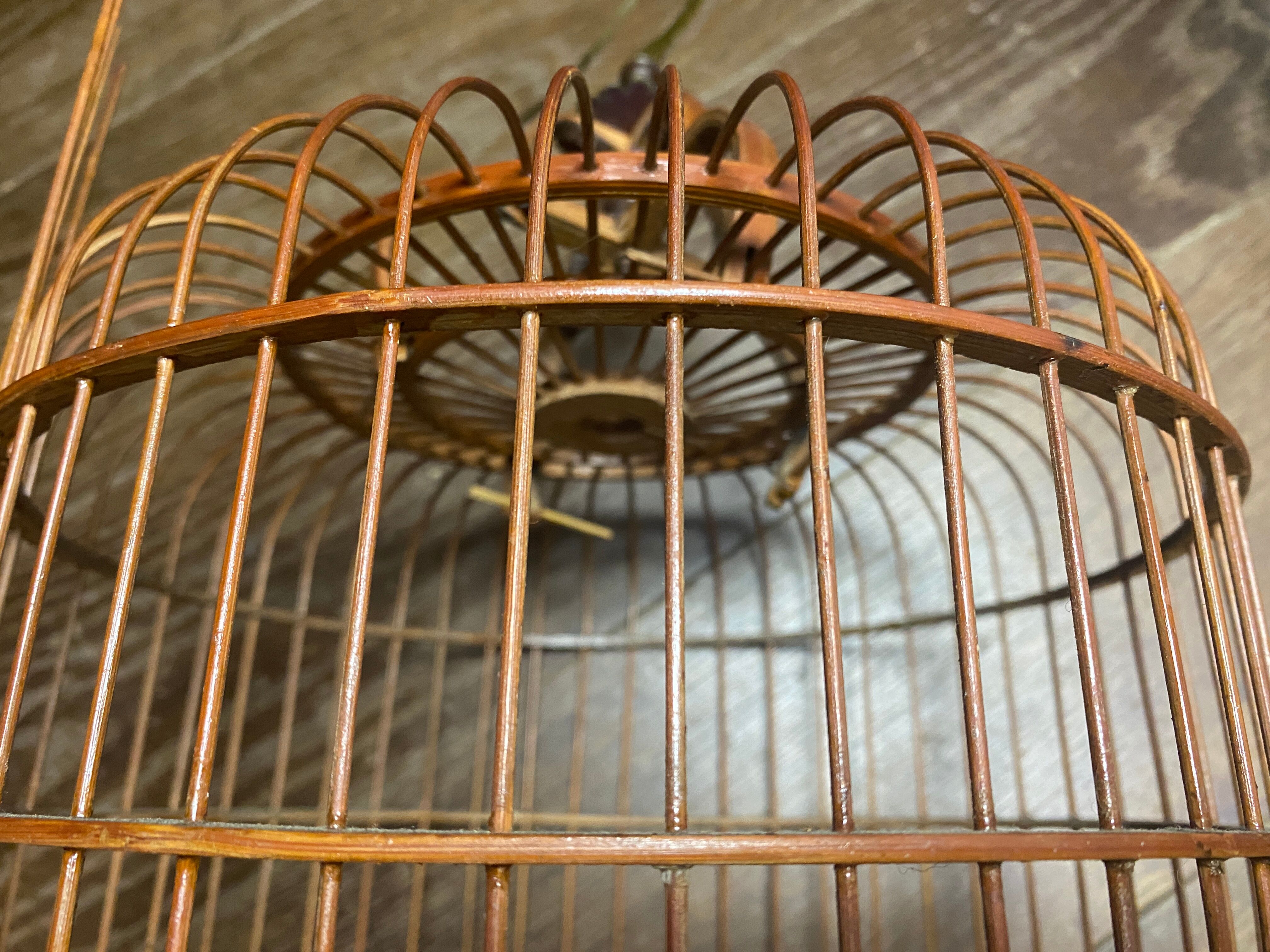 Old bird cage made of bamboo and wood