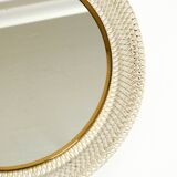Mid Century Modern round wall mirror with a white expanded metal frame