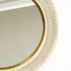 Mid Century Modern round wall mirror with a white expanded metal frame