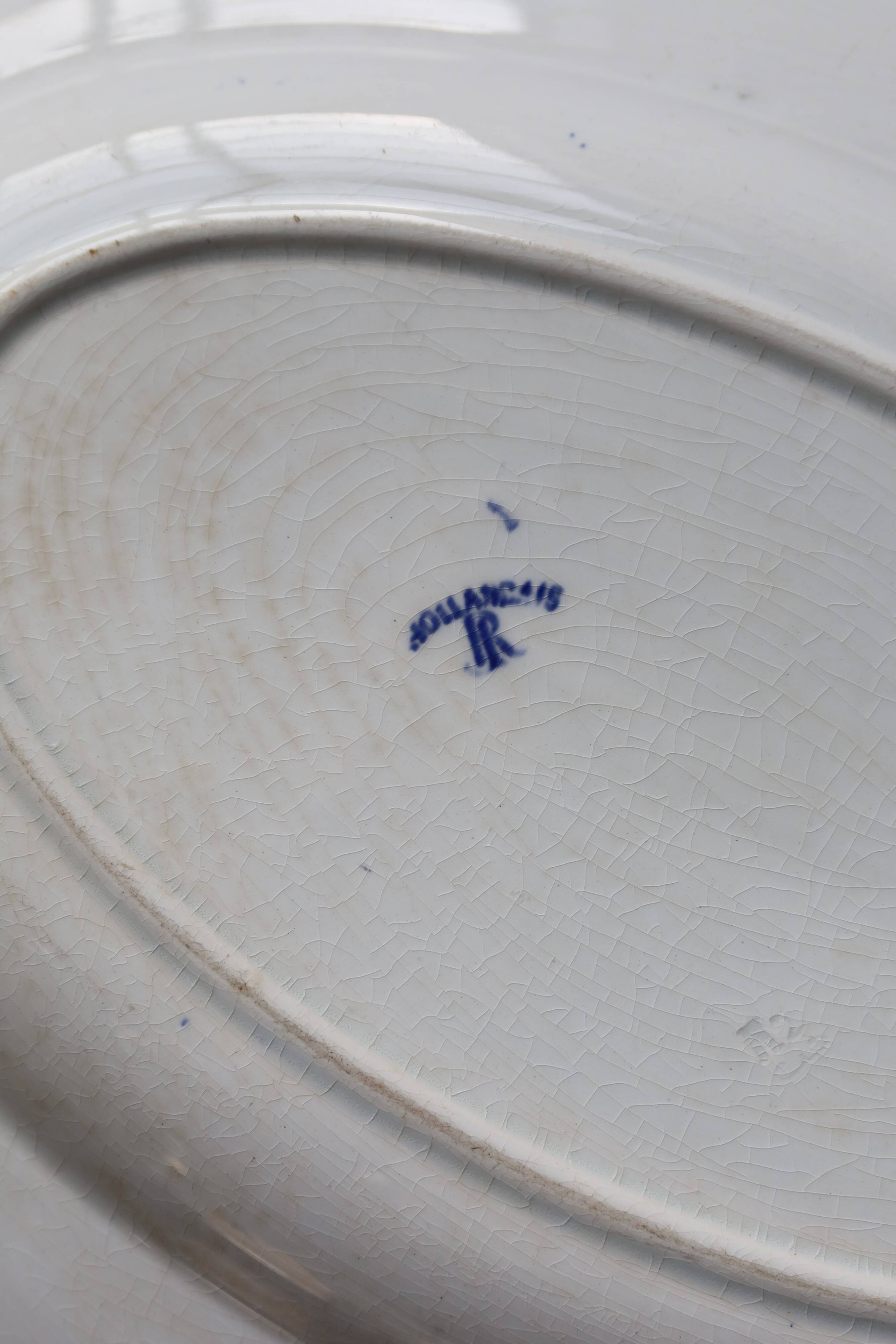 Antique serving dish in white and blue earthenware.
