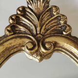 Classic Baroque/Louis XV style mirror. In old gold patinated wood. Palmette/Scroll/Blazon motif decor. Dim 46 x 27 cm