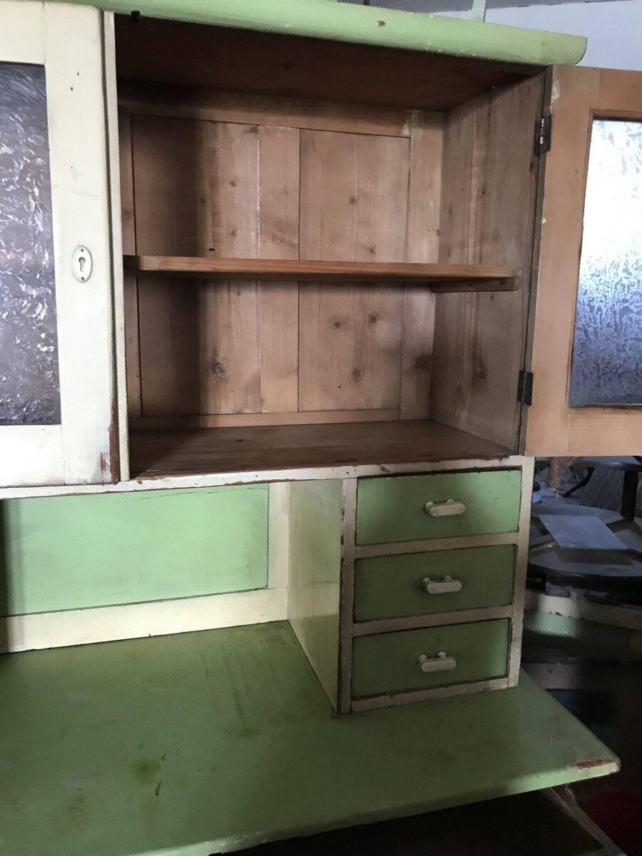 Vintage wooden kitchen cupboard painted green and beige, with glass doors - 1930s