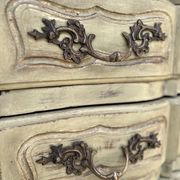 Curved antique commode in pistachio green patina.