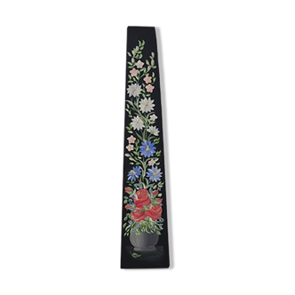 Black wooden wall shelf with flowers