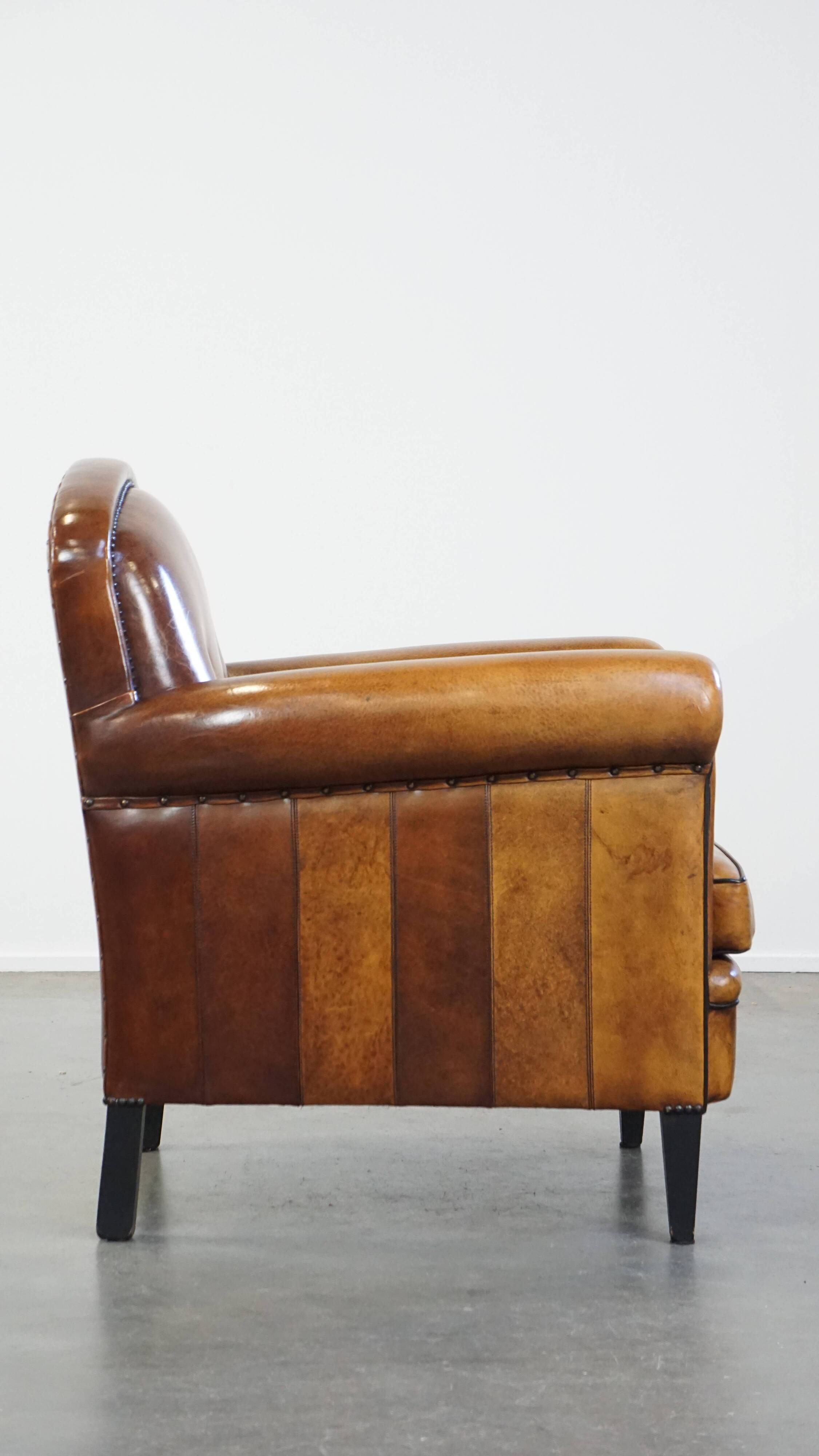 Sheep leather design armchair finished with decorative nails and black piping