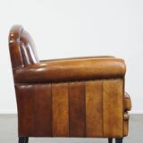 Sheep leather design armchair finished with decorative nails and black piping