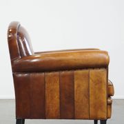 Sheep leather design armchair finished with decorative nails and black piping
