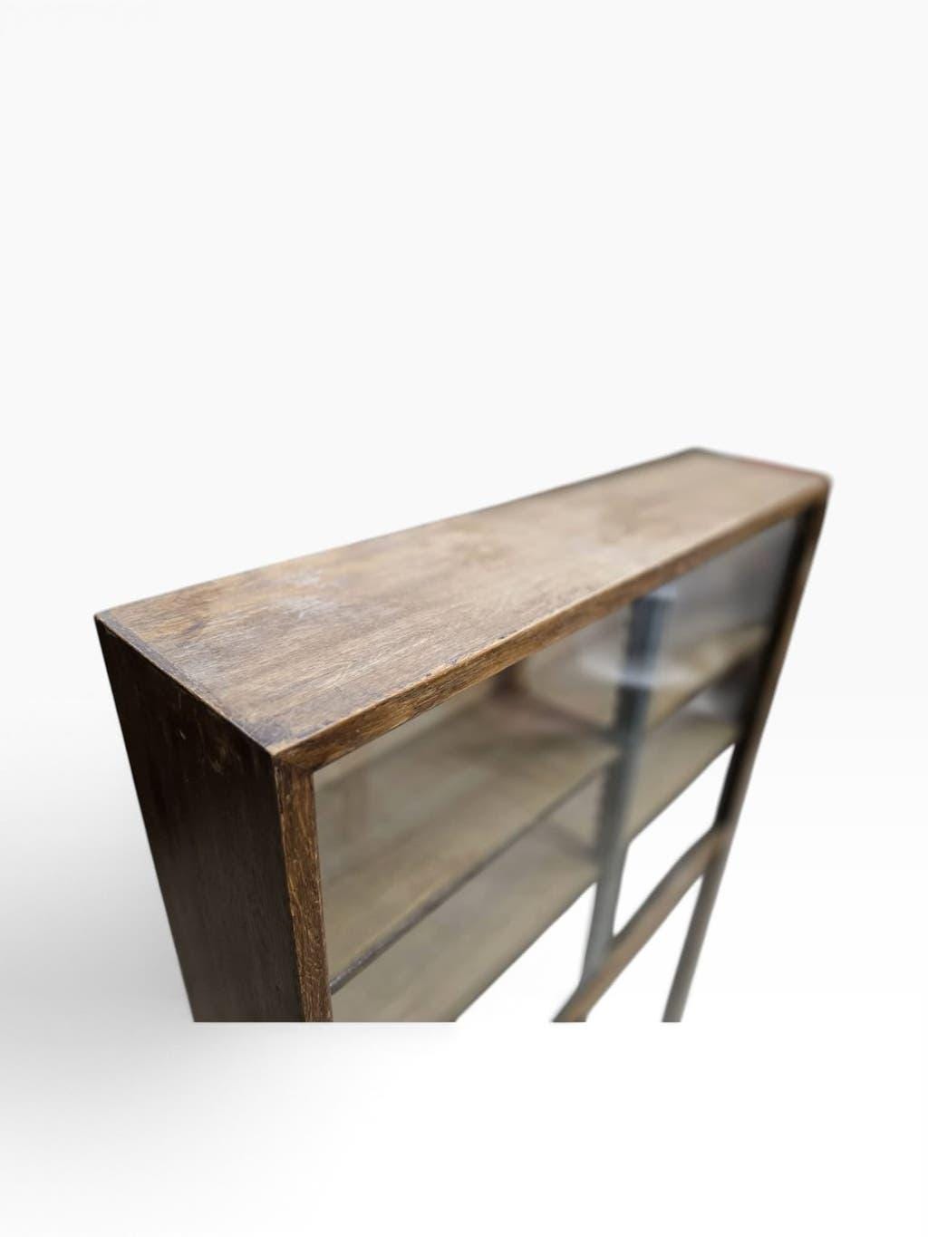 Vintage shallow wooden display shelf with sliding glass doors.