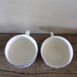 A set of two Digoin earthenware cups with blue, red, and yellow flowers.