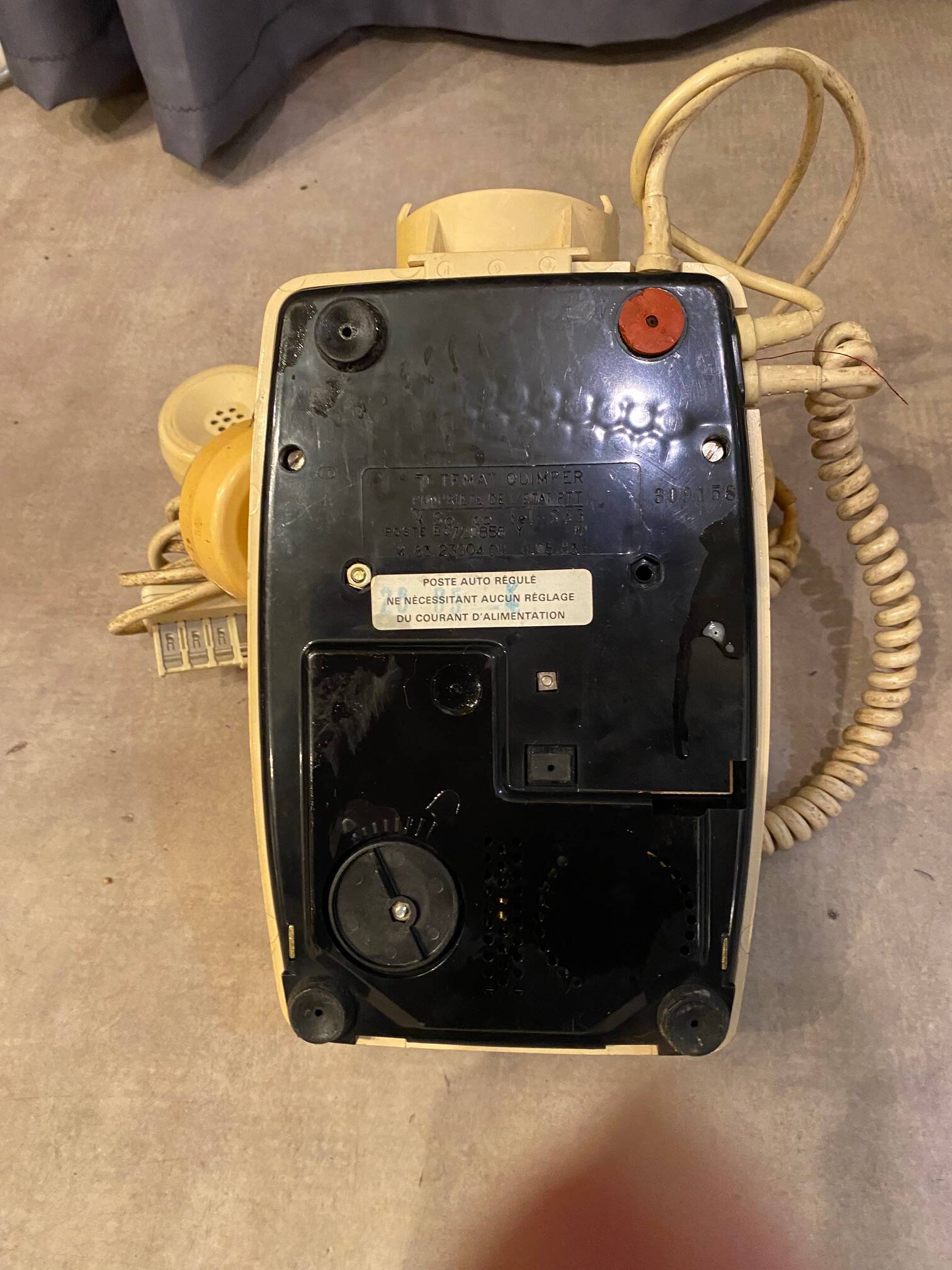 Old dial telephone from the 80s temat quimper bakelite yellow and beige