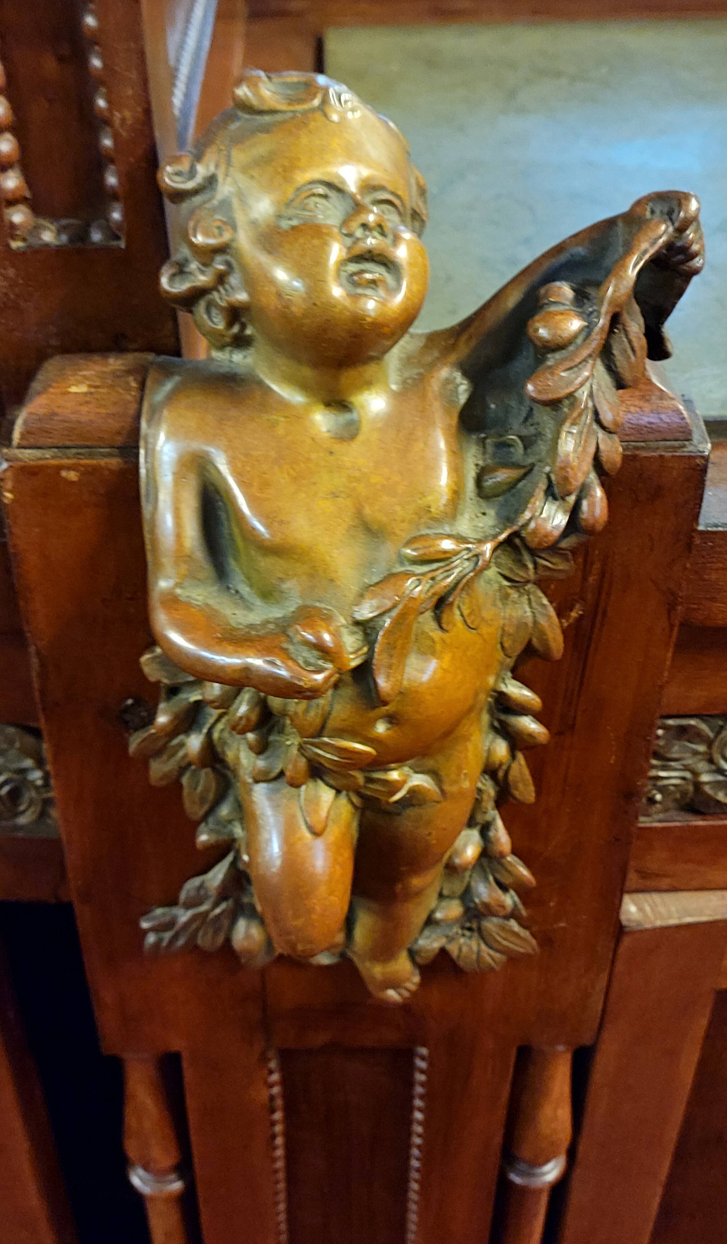 Empire style half-moon shaped mahogany bookcase with putti