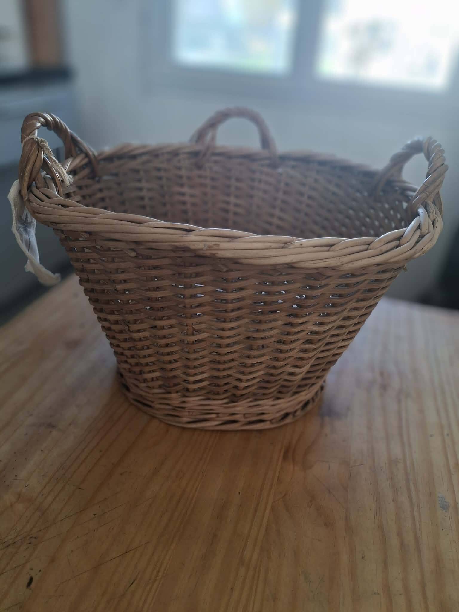 Old wicker basket with 3 handles.