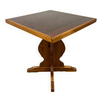 Wooden table with laminated top and carved central foot 1970s France