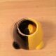 Two-tone ceramic ashtray in yellow and black, vintage 1950s.